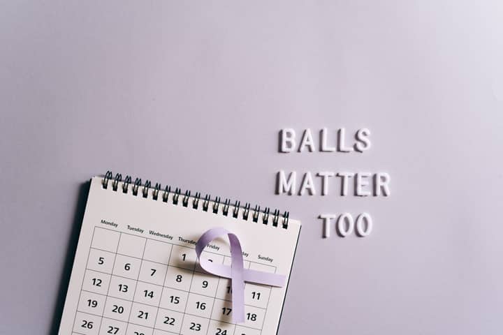 Calendar with ribbon promoting testicular cancer awareness on a light background.