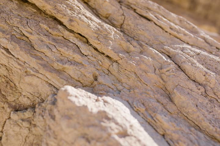 Detailed close-up of textured rock formation capturing natural patterns and rough surface.