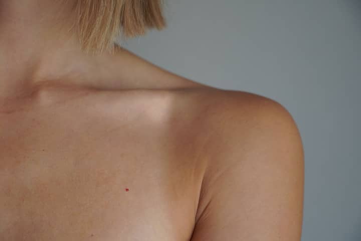 Detailed view of a woman's shoulder and skin tone with natural lighting.