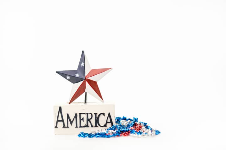 Red, white, and blue American star with decorative tinsel, perfect for Independence Day celebrations.