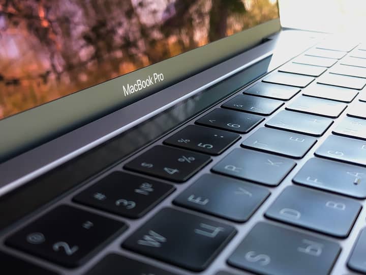 A detailed close-up of a MacBook Pro keyboard, highlighting keys and reflection.