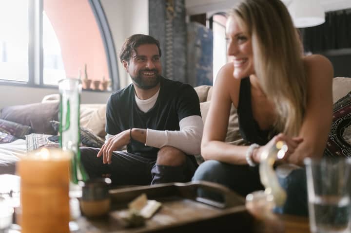 Two friends sharing laughter and conversation in a cozy indoor setting.