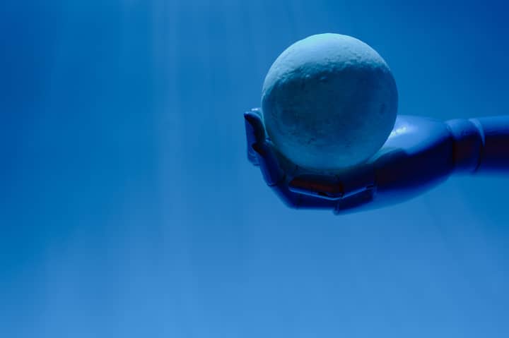 A robotic hand holds a glowing celestial sphere against a blue background, evoking a futuristic theme.
