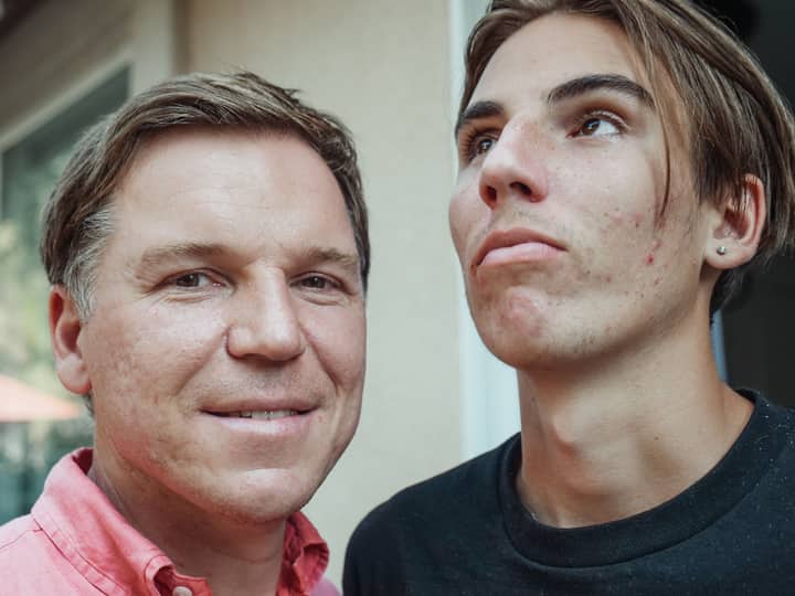 Close-up of father and teenage son posing together, showcasing family resemblance and natural expressions.
