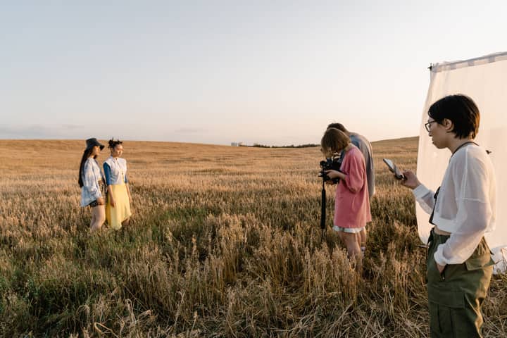 Stylish photo shoot with models in a rustic countryside setting.