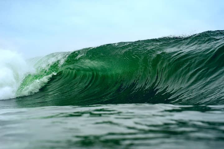 A magnificent green ocean wave in Iquique, Chile, capturing nature's power and beauty.