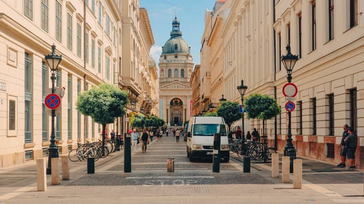 St Stephen's Basilica amidst Budapest's historic architecture, capturing daily life and tourism.
