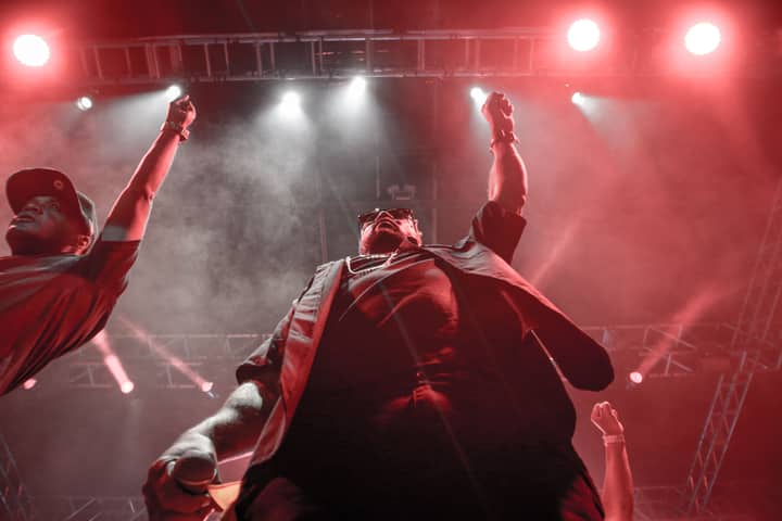 Dynamic stage performance with vibrant red lighting and audience engagement.