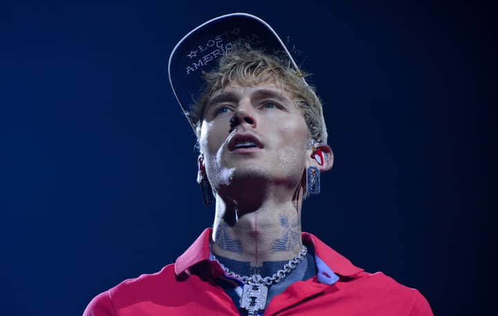 Watch MGK “mess my back up really, really bad” as he somersaults off roof into audience